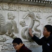 Prayer and dance: hundreds of millions in Asia celebrate Year of the Snake