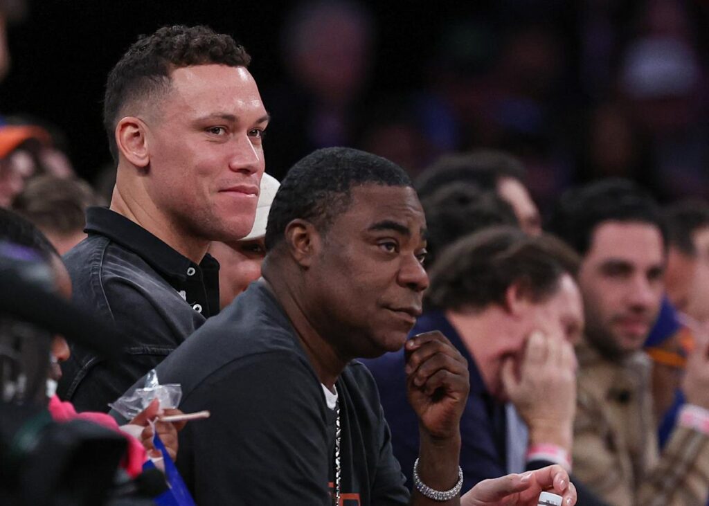 Comedian Tracy Morgan wheeled off after vomiting on Madison Square Garden court, leading to delay in Knicks-Heat game